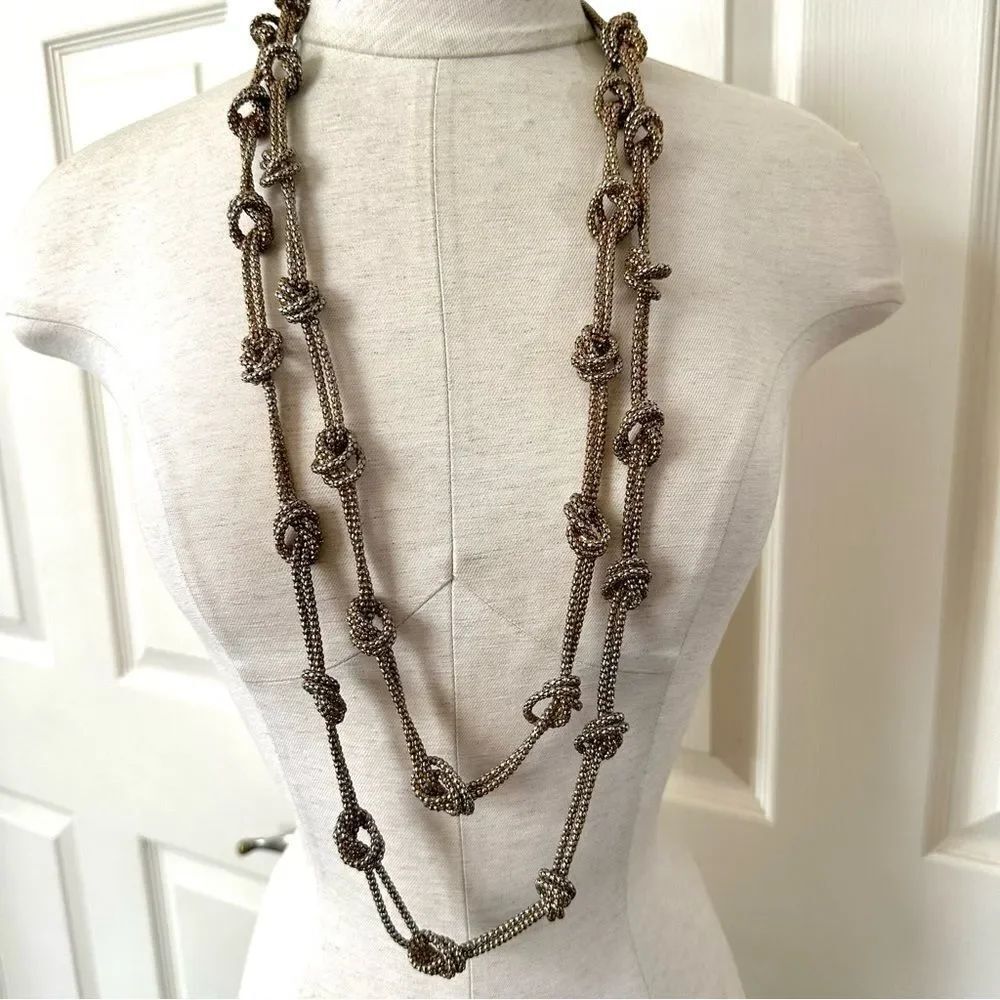 Long gold tone knotted necklace
